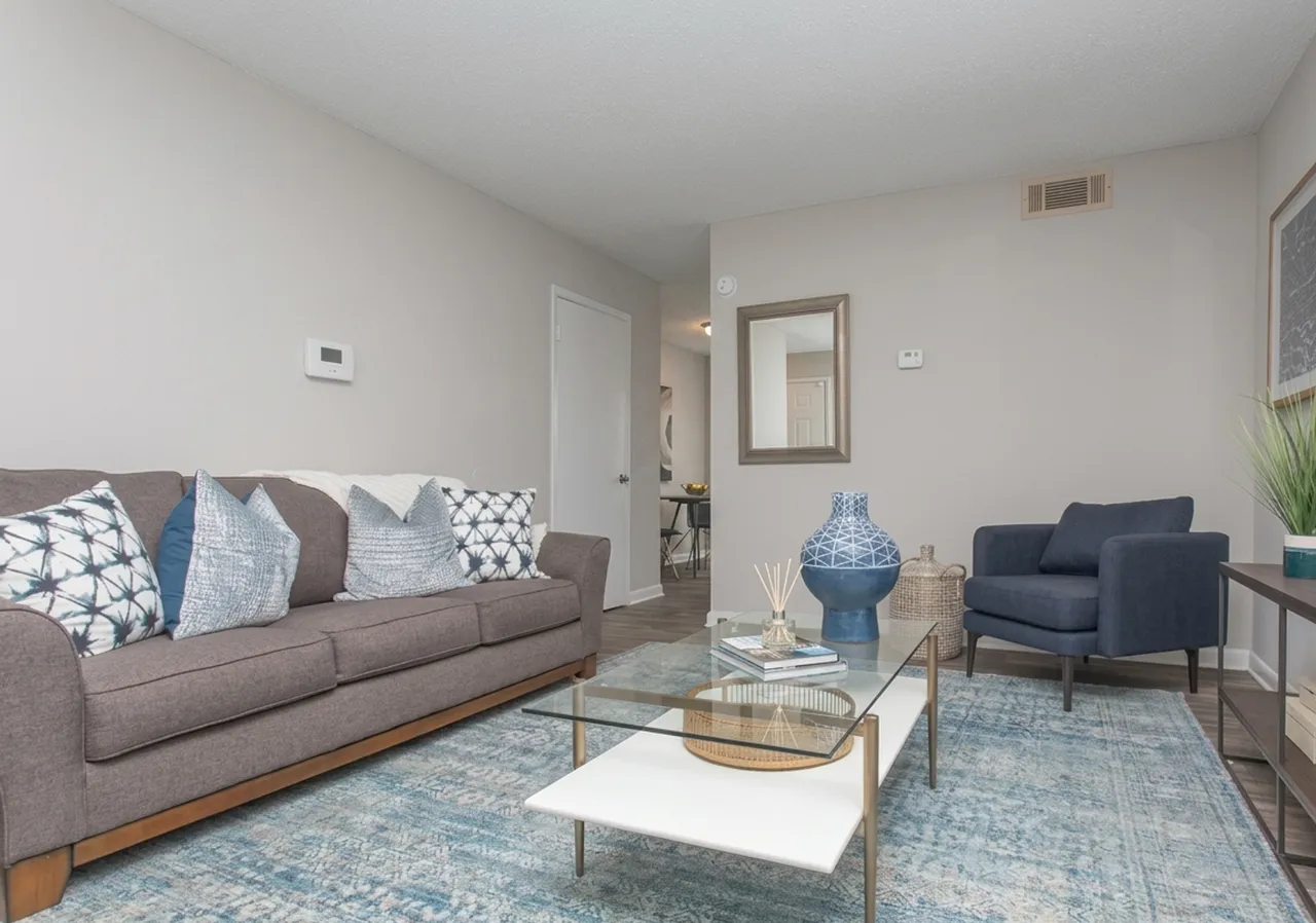 Three-bedroom living room with a sofa, armchair and coffee table